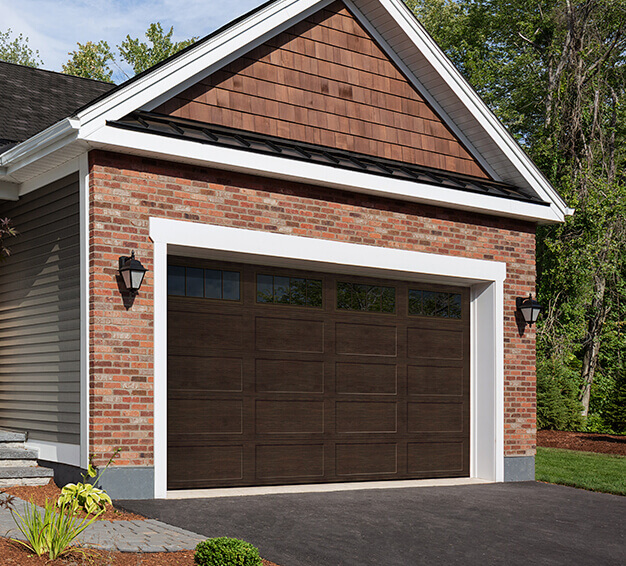 Simple Traditional Style garage doors with the Regal Shaker‑Flat Long design in the Dark Walnut colour