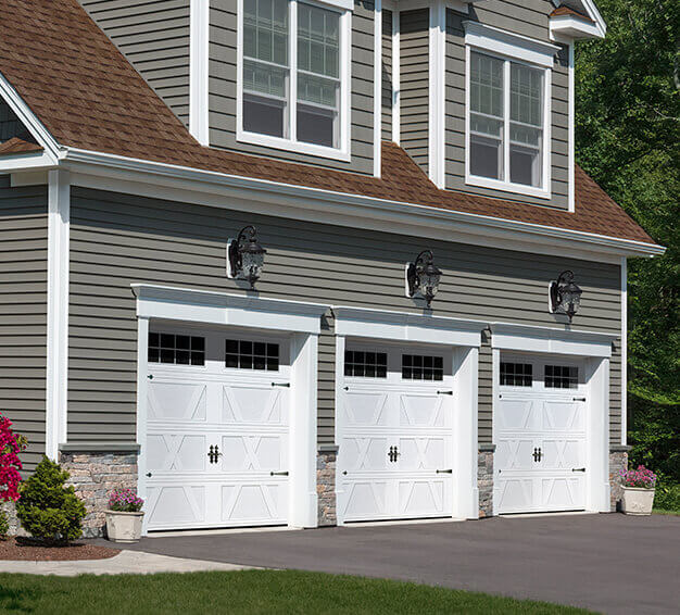 3 Carriage House Style garage doors with the X Layout, Flat base design in the Ice White color