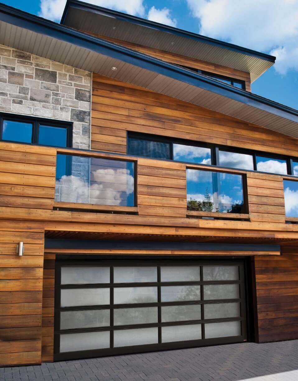 A Scandinavian Exterior House, with a full-view California double garage door, 16' x 7', Black aluminum frame, Sandblasted glass