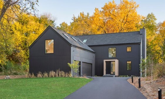 Cet extérieur moderne scandinave sur Houzz montre comment des portes de garage noires s'accordent avec un revêtement extérieur gris fer très foncé