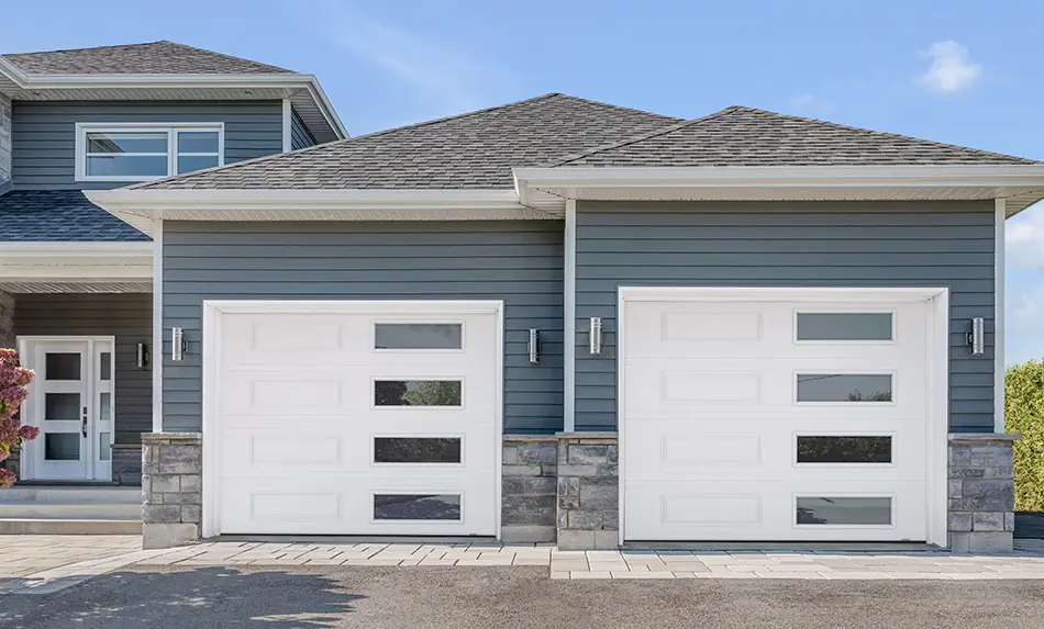 A traditional renovated with a more modern twist, Garaga garage doors with Right-Harmony windows with new trending Tinted glass.