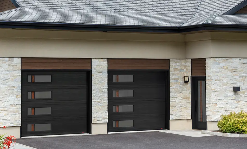 Traditional exterior renovated with Novatech black entry door and Garaga garage doors both with Zen Walnut glass for a more contemporary look