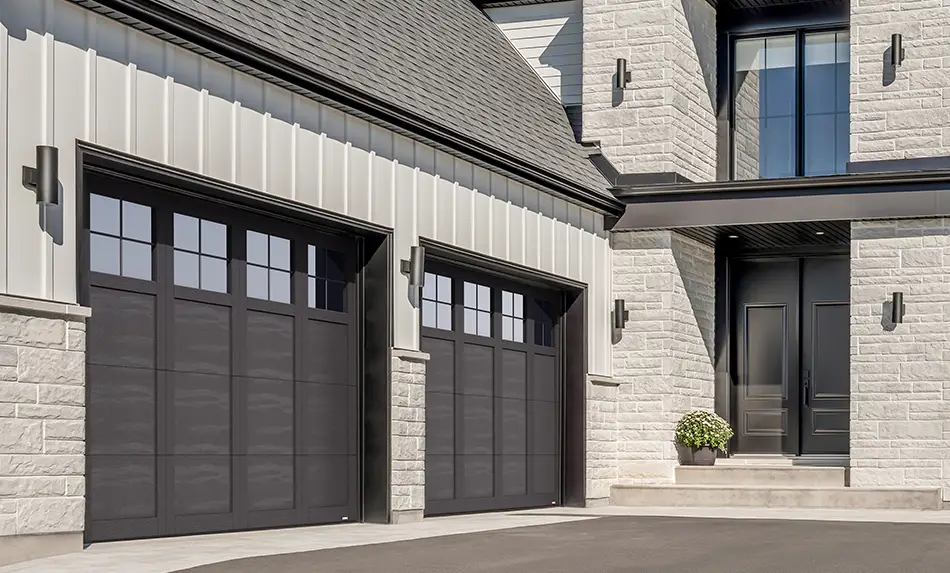 Black and white transitional house with Garaga garage doors Princeton P-31 design, Black steel doors and overlays.