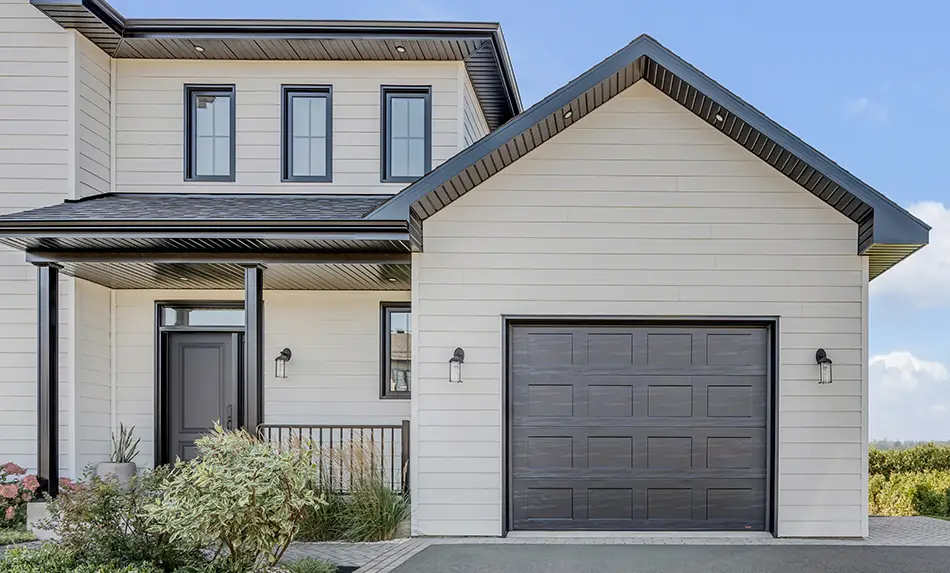 Black and white  modern farmhouse with a Garaga Shaker-Flat CC garage door in Black. Made in Canada and built to last.