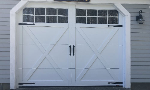 Gray house with Eastman E-21 garage door, 9' x 7', Ice White door and overlays, Panoramic 8 lites windows
