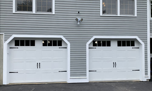 Gray house with Shaker-CS Short garage doors, 9' x 7', White, Orion 8 lite windows