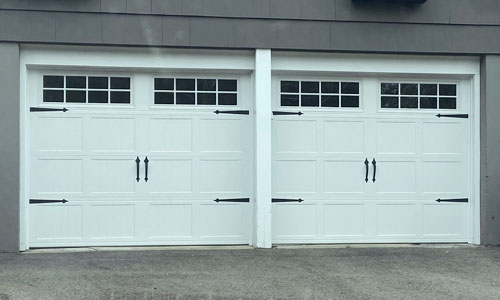 Gray vinyl house with Shaker-CS Short garage doors, 9' x 7', White, Orion 4 lite windows