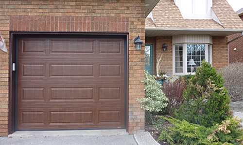 Brick brown house with Classic MIX garage door, 8' x 7', American Walnut Faux Wood