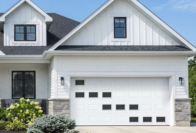 House featuring a garage door with a custom window layout