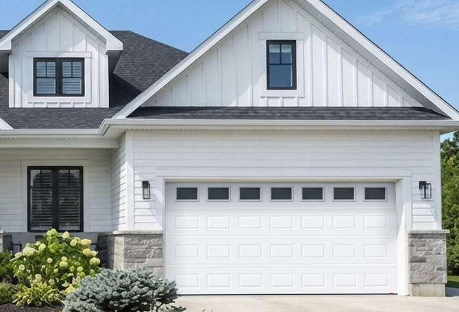House featuring a garage door with windows along the top row