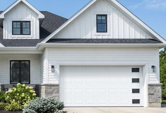 House featuring a garage door with windows on the right side