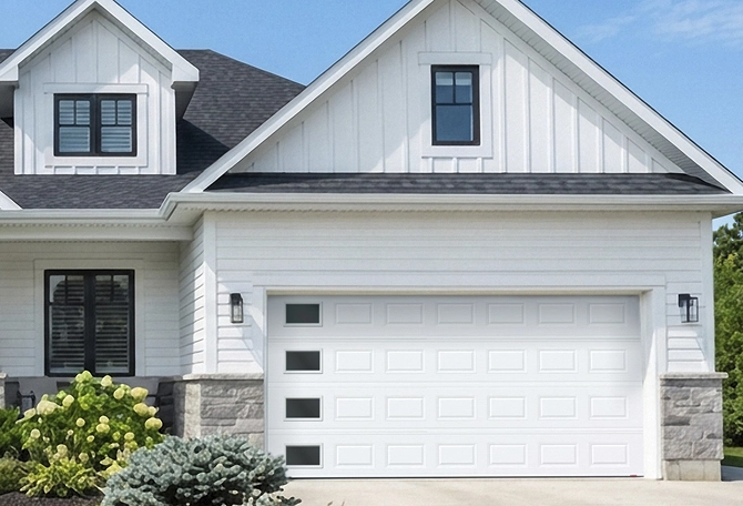 House featuring a garage door with windows on the left side