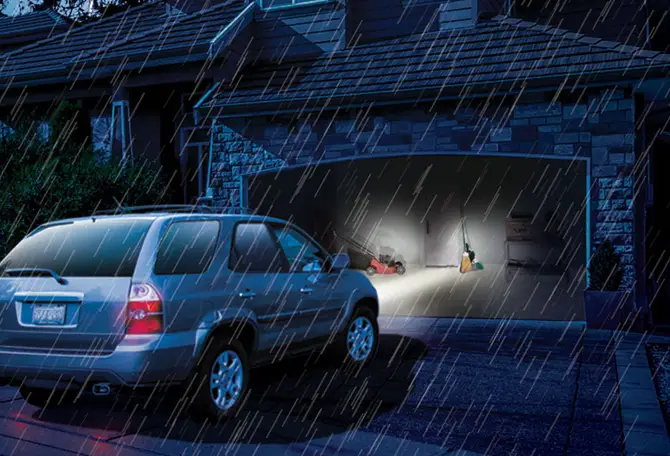 A garage with its garage door opened even though there is a power outage, thunder, and strikes thanks to its garage door opener battery back up.