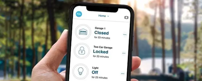 A person holding a cell phone with the MyQ app on the screen