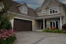 Traditional 2-stories house. Garage door is a North Hatley LP, 16' x 8', Moka Brown color, 4 vertical lite Orion windows