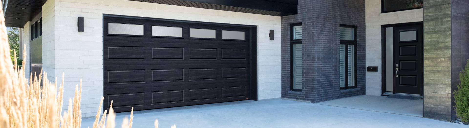 Contemporary style house with a Shaker-Modern XL garage door, Garaga’s latest design, in Black