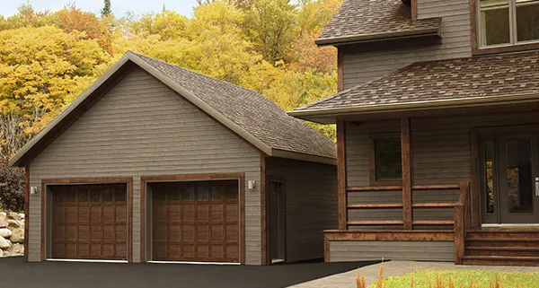 Carriage house style home with Cambridge CS garage door in Chocolate Walnut.