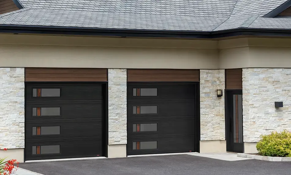 Traditional exterior renovated with Novatech black entry door and Garaga garage doors both with Zen Walnut glass for a more contemporary look