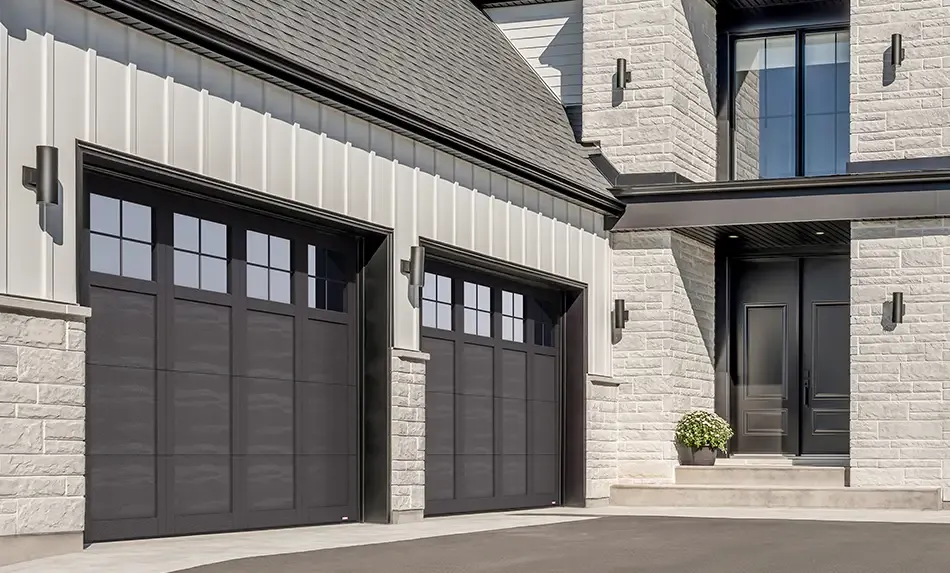 Black and white transitional house with Garaga garage doors Princeton P-31 design, Black steel doors and overlays.