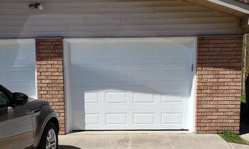 Brick house with Classic CC garage doors, 9' x 7', Ice White