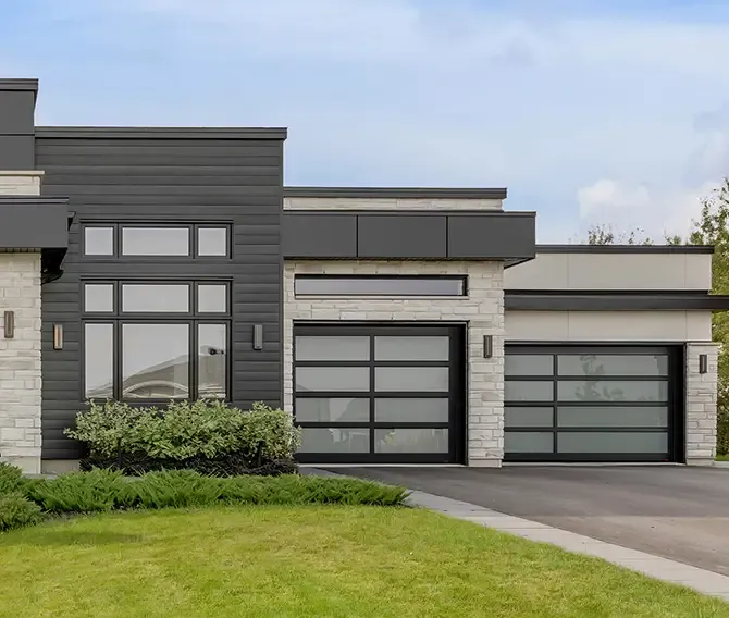 Maison moderne contemporaine avec portes de garage toutes vitrée California de Garaga faites au Québec, Canada